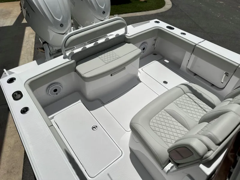 Slide: The Image of 2025 Jupiter 32 boat interior with white seating and storage compartments. - 36
