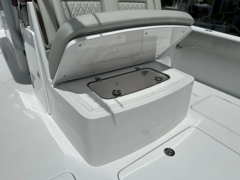 Slide: The Image of Open storage compartment on 2025 Jupiter 32 boat with cushioned seating. - 38