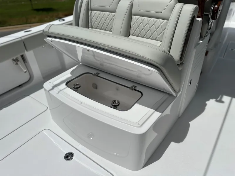 Slide: The Image of 2025 Jupiter 32 boat with open storage compartment and cushioned seating. - 39