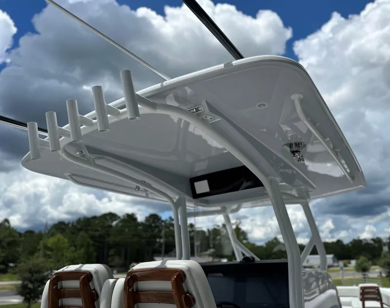 Slide: The Image of Jupiter 32 boat's helm with rod holders, under a cloudy sky, 2025 model. - 40