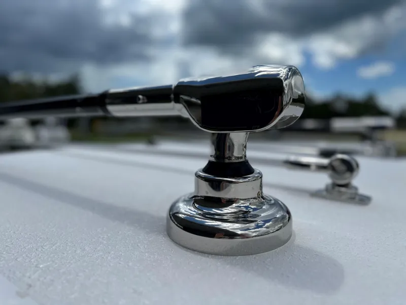 Slide: The Image of Close-up of a chrome fitting on a 2025 Jupiter 32 boat under cloudy sky. - 41