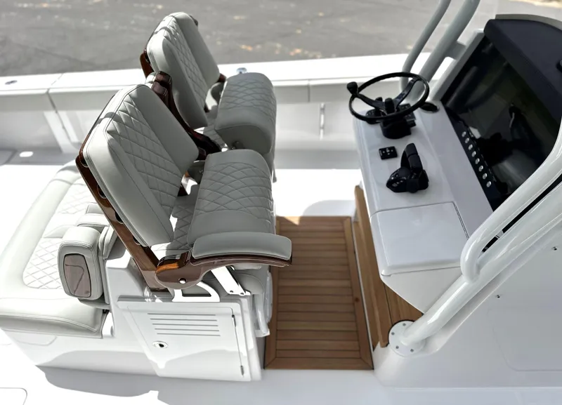 Slide: The Image of Luxury seating and helm of 2025 Jupiter 32 boat, featuring modern design and controls. - 44