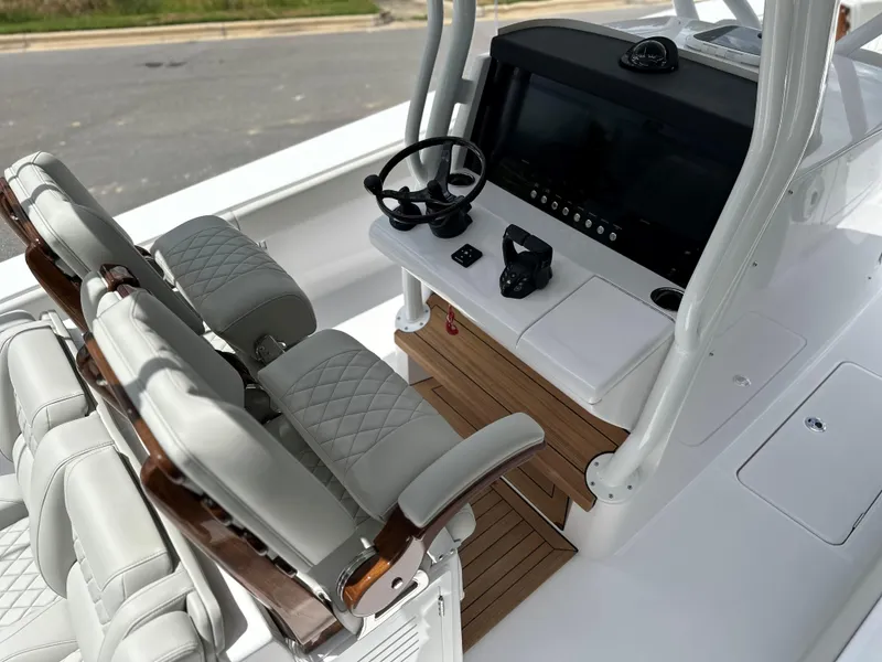 Slide: The Image of Jupiter 32 boat cockpit, 2025 model, featuring modern steering and seating. - 45