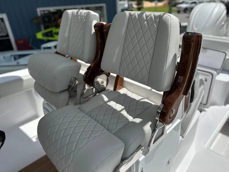 Slide: The Image of Luxurious seating on 2025 Jupiter 32 boat with diamond-stitched upholstery and wooden accents. - 5