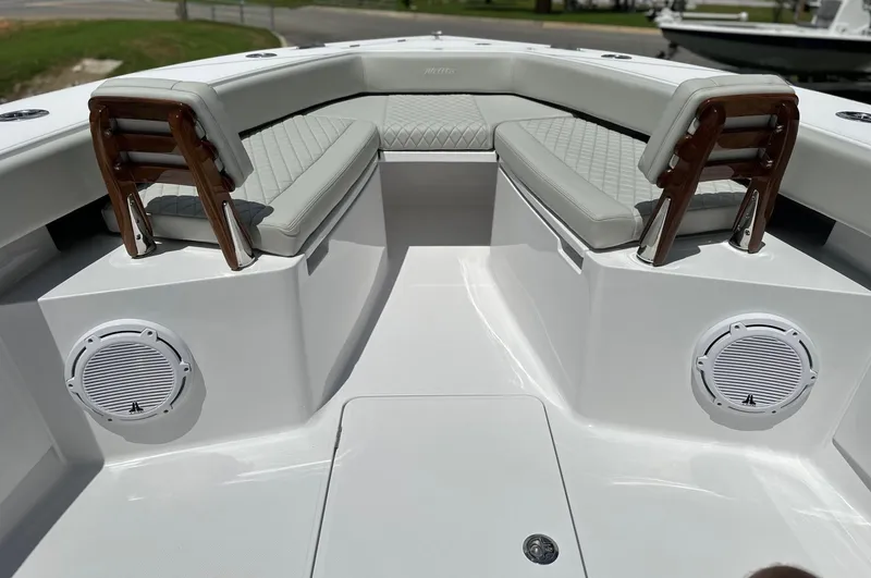 Slide: The Image of 2025 Jupiter 32 boat interior with cushioned seating and built-in speakers. - 8