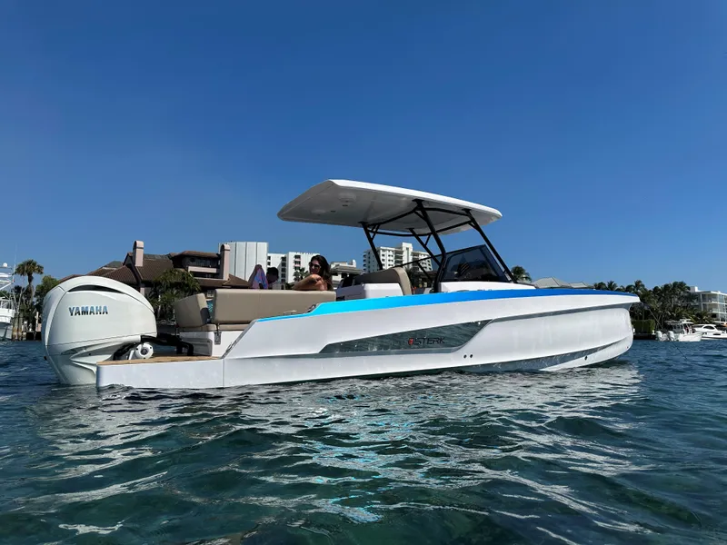 Slide: The Image of 2025 STERK 31 WB Sport boat on water, featuring sleek design and Yamaha engine. - 1