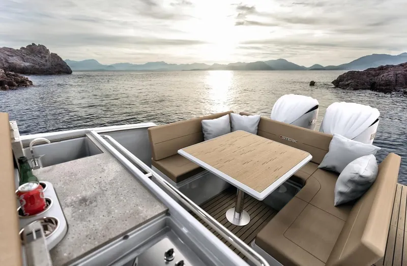 Slide: The Image of Luxurious 2025 STERK 31 WB Sport yacht interior with ocean view at sunset. - 31