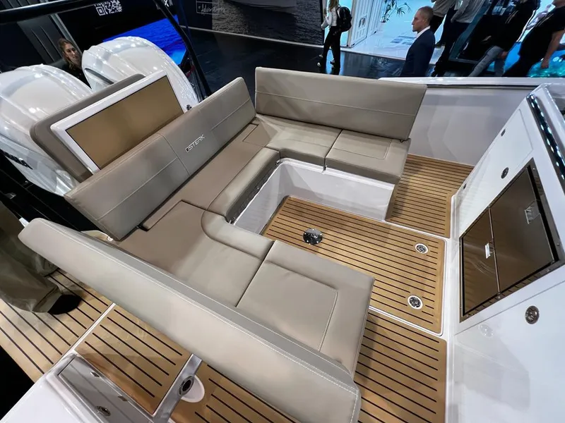 Slide: The Image of 2025 STERK 31 WB Sport boat interior with beige seating and teak flooring. - 43