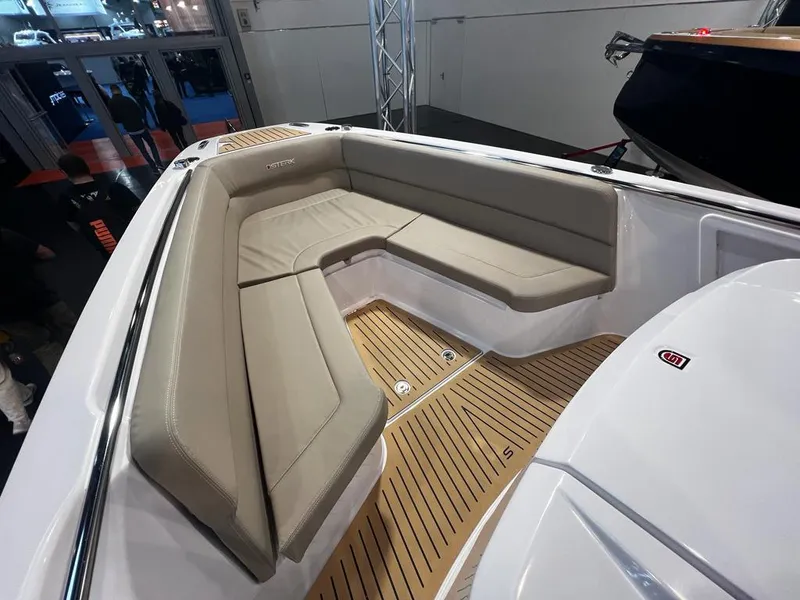Slide: The Image of Luxurious seating area on 2025 STERK 31 WB Sport boat with sleek design and wood flooring. - 44