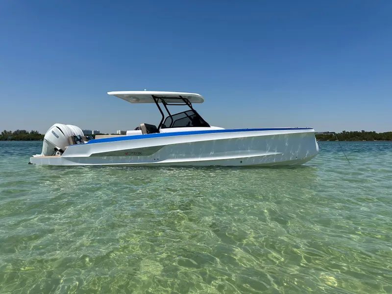 Slide: The Image of 2025 STERK 31 WB Sport boat on clear water under blue sky. - 5