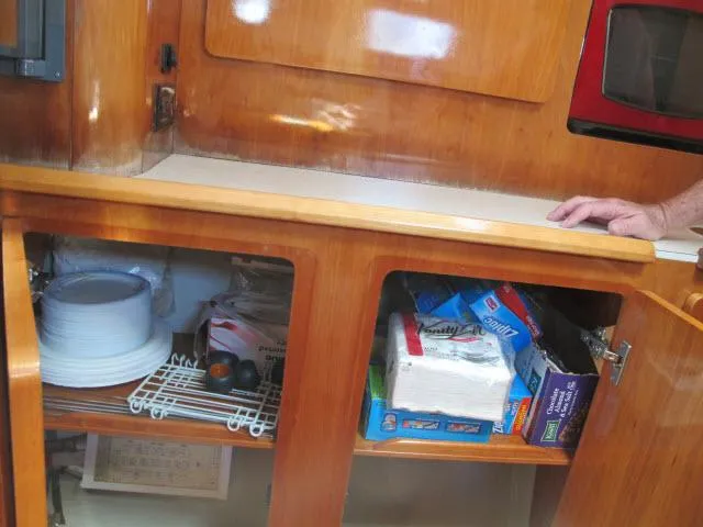Slide: The Image of Interior of 2000 Alliaura Privilege 37 yacht kitchen with wooden cabinets and storage. - 13