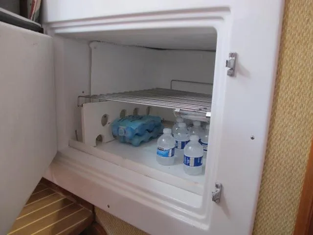 Slide: The Image of Open fridge on Alliaura Privilege 37 yacht, stocked with water bottles, 2000 model. - 15