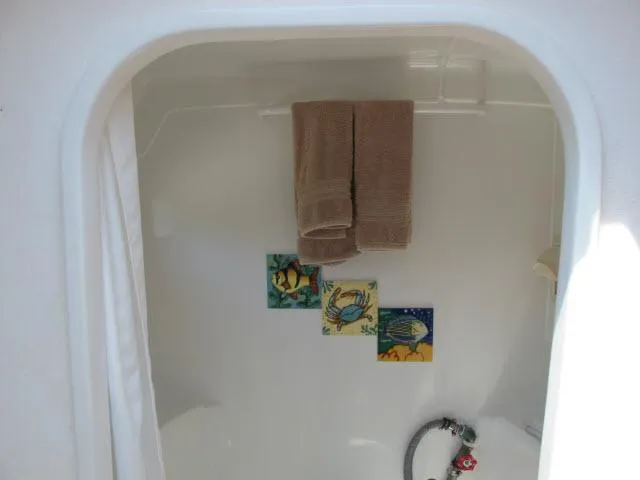 Slide: The Image of Shower area in 2000 Alliaura Privilege 37 catamaran with decorative tiles and towels. - 19