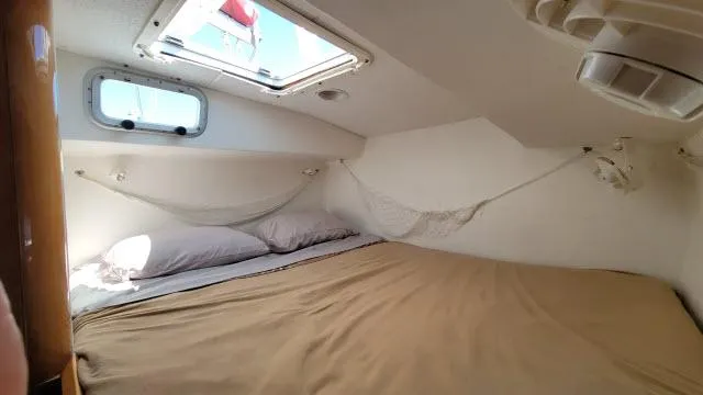 Slide: The Image of Cozy cabin interior of 2000 Alliaura Privilege 37 catamaran with bed and porthole. - 22
