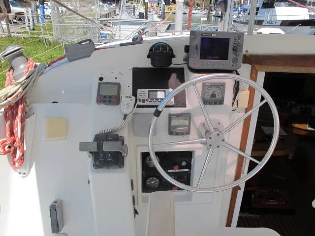 Slide: The Image of Cockpit of 2000 Alliaura Privilege 37 catamaran with navigation instruments and steering wheel. - 29