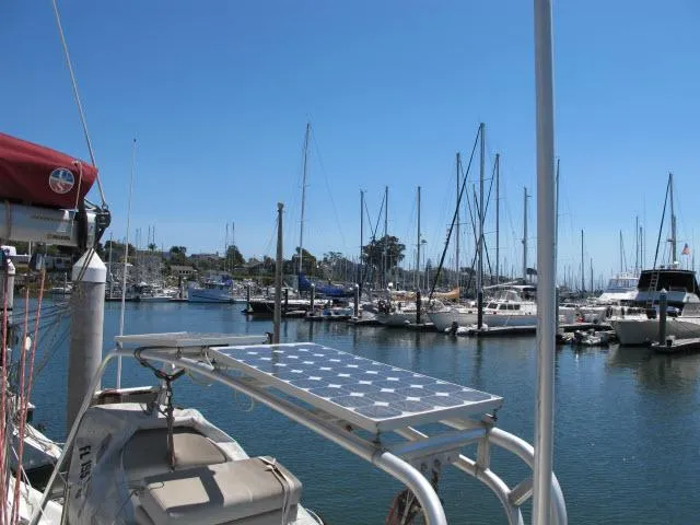 Slide: The Image of Alliaura Privilege 37 catamaran docked in a marina, featuring a solar panel, clear blue sky. - 34