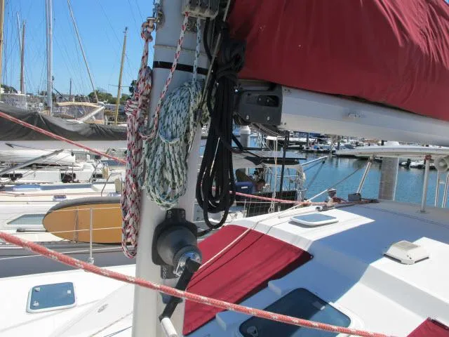Slide: The Image of Alliaura Privilege 37 catamaran, 2000 model, docked with red sail cover and ropes. - 36