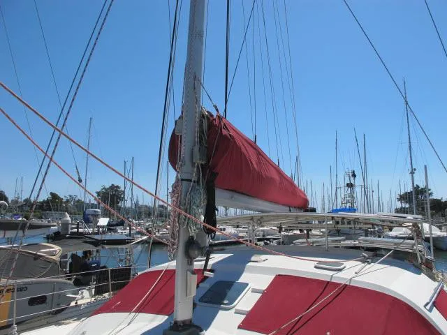Slide: The Image of Alliaura Privilege 37 catamaran, 2000 model, docked with red sail cover. - 38