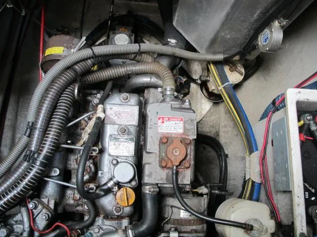 Slide: The Image of Engine compartment of 2000 Alliaura Privilege 37 catamaran, showing mechanical components and wiring. - 46