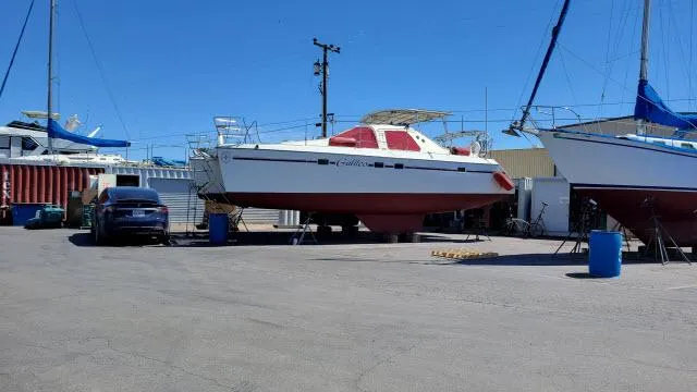 Slide: The Image of Alliaura Privilege 37 catamaran from 2000 on dry dock, surrounded by boats and vehicles. - 49