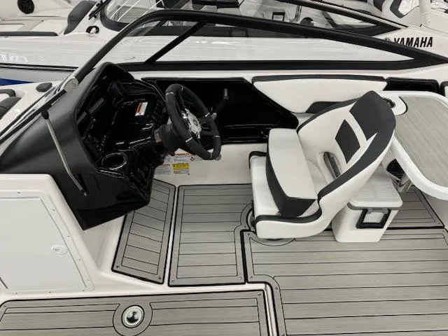 Slide: The Image of 2025 Yamaha Boats 195S interior with sleek black and white seating and modern dashboard. - 7