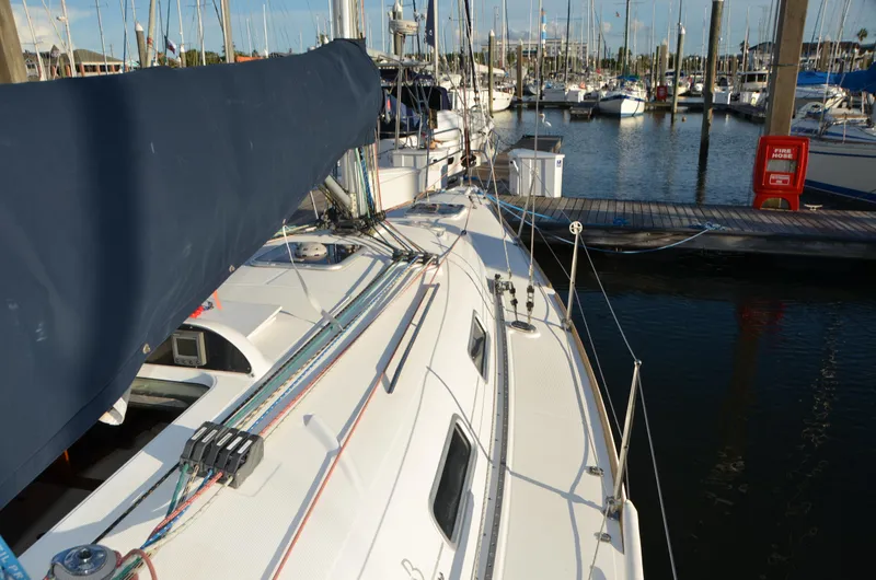 Slide: The Image of 2002 Beneteau First 36.7 sailboat docked in a marina, showcasing deck and rigging. - 11