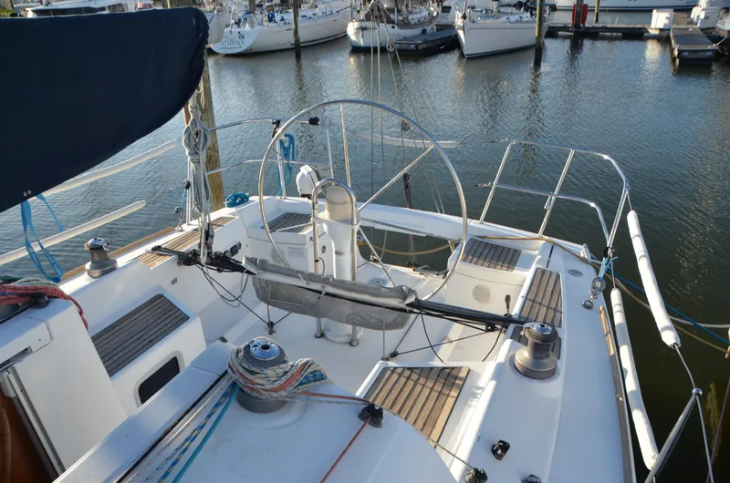 Slide: The Image of 2002 Beneteau First 36.7 sailboat cockpit with steering wheel, docked in marina. - 12