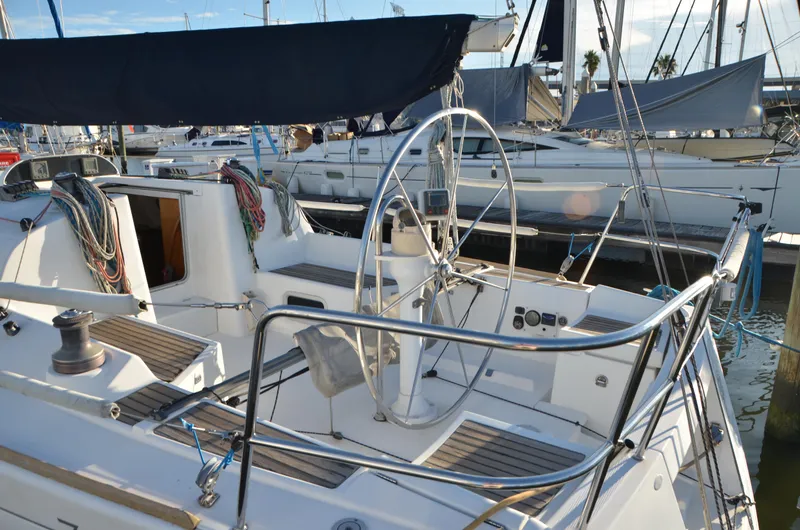 Slide: The Image of Beneteau First 36.7 sailboat, 2002 model, docked with visible cockpit and steering wheel. - 13