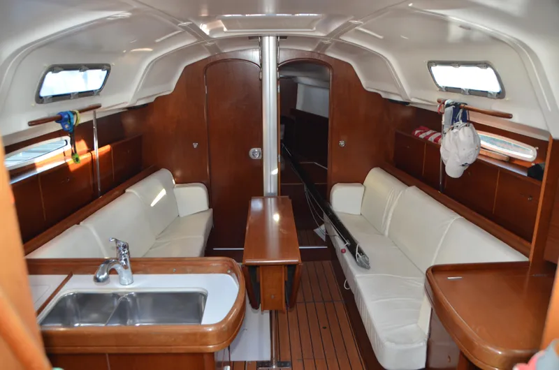 Slide: The Image of Interior of 2002 Beneteau First 36.7 sailboat with wood finish and white seating. - 16