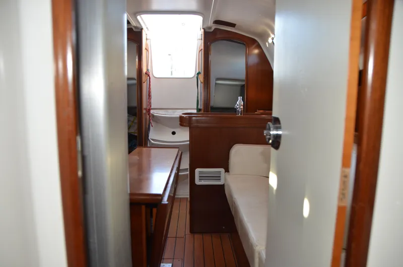 Slide: The Image of Interior of 2002 Beneteau First 36.7 sailboat, featuring wood finishes and seating area. - 21