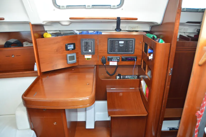 Slide: The Image of Interior of 2002 Beneteau First 36.7 sailboat with navigation equipment and wooden cabinetry. - 24