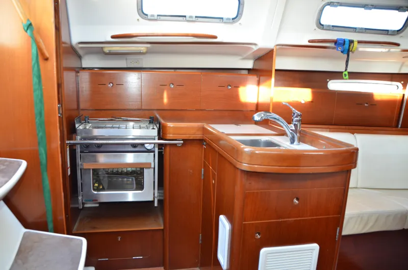 Slide: The Image of Interior of 2002 Beneteau First 36.7 yacht with wooden cabinetry and compact kitchen. - 25
