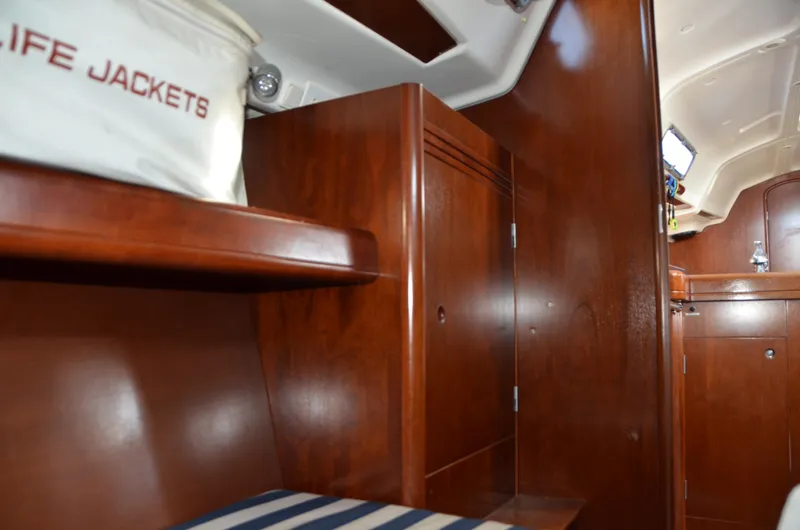 Slide: The Image of Interior of 2002 Beneteau First 36.7 sailboat with wooden cabinetry and life jackets. - 30
