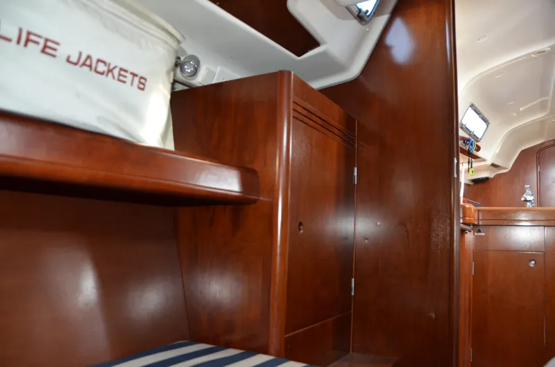 Slide: The Image of Interior of 2002 Beneteau First 36.7 sailboat with wooden cabinetry and life jackets. - 31
