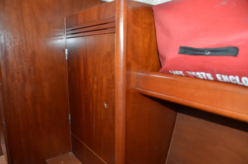 Slide: The Image of Interior of 2002 Beneteau First 36.7 yacht with wooden cabinetry and red storage bag. - 34