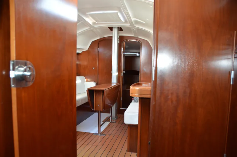 Slide: The Image of Interior of 2002 Beneteau First 36.7 sailboat with wooden finish and compact layout. - 35