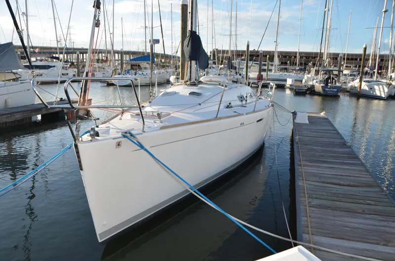 Slide: The Image of 2002 Beneteau First 36.7 sailboat docked in marina, surrounded by other boats. - 4