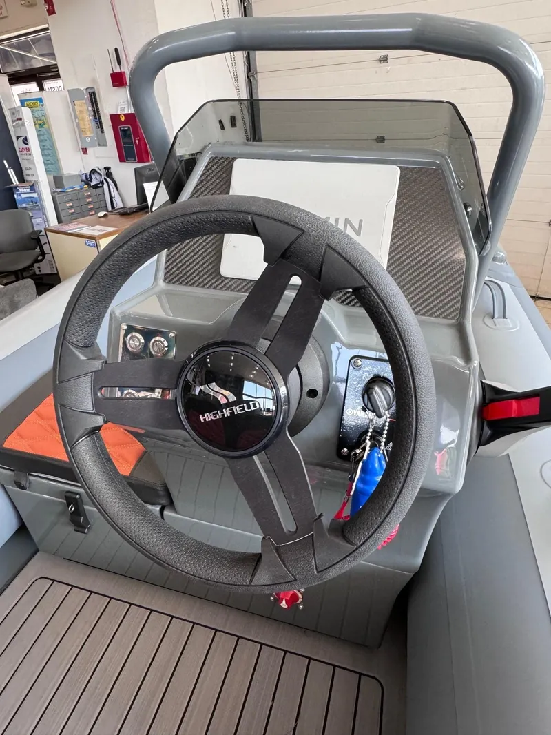 Slide: The Image of 2024 Highfield Sport 330 steering wheel and dashboard in a showroom. - 2