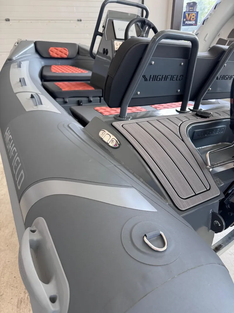 Slide: The Image of 2024 Highfield Sport 330 inflatable boat interior with seating and controls. - 7