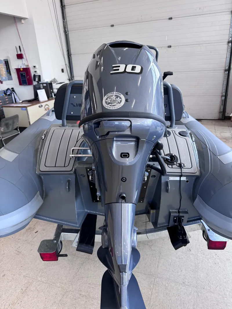 Slide: The Image of 2024 Highfield Sport 330 boat with 30 HP engine in a showroom. - 9