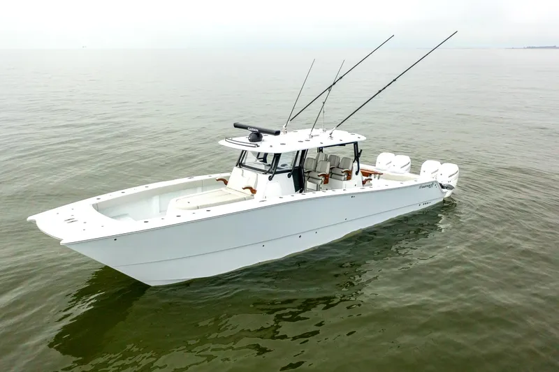 The Image of 2023 Freeman 42 LR boat on calm water, featuring sleek design and multiple fishing rods. - 1
