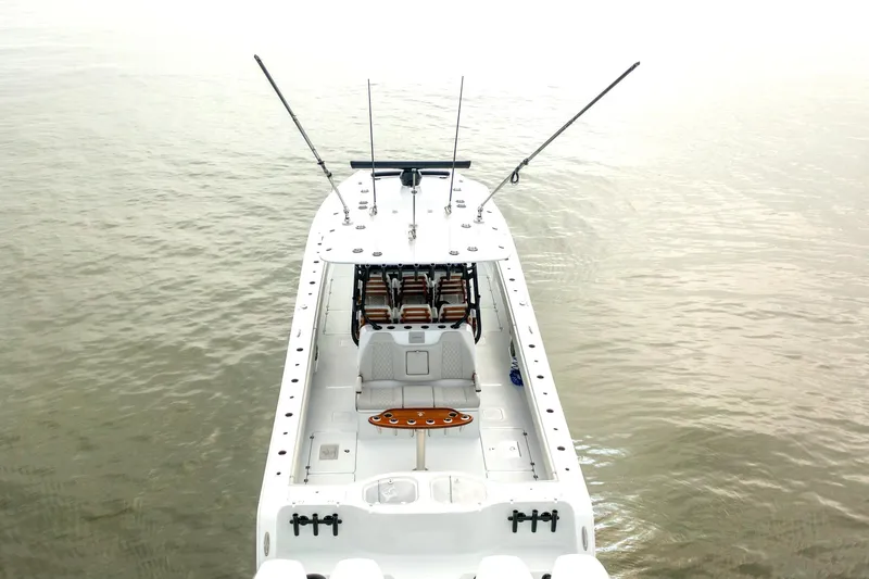 Slide: The Image of Freeman 42 LR 2023 boat on calm water, aerial view, fishing rods visible. - 8