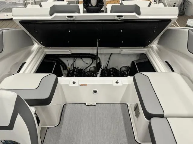 Slide: The Image of 2025 Yamaha Boats AR220 engine compartment with open hatch, showcasing interior design. - 14