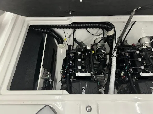 Slide: The Image of 2025 Yamaha AR220 boat engine compartment with dual engines and wiring. - 15