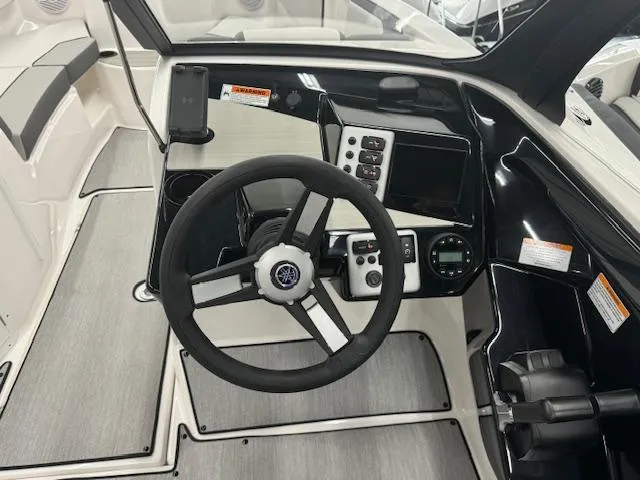 Slide: The Image of 2025 Yamaha Boats AR220 cockpit with steering wheel and control panel. - 7