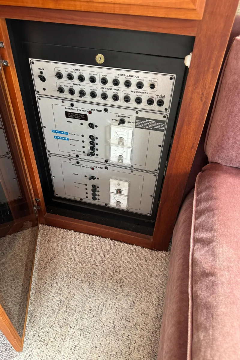 Slide: The Image of Control panel inside 1986 Carver Mariner 3297 yacht, featuring various switches and dials. - 13