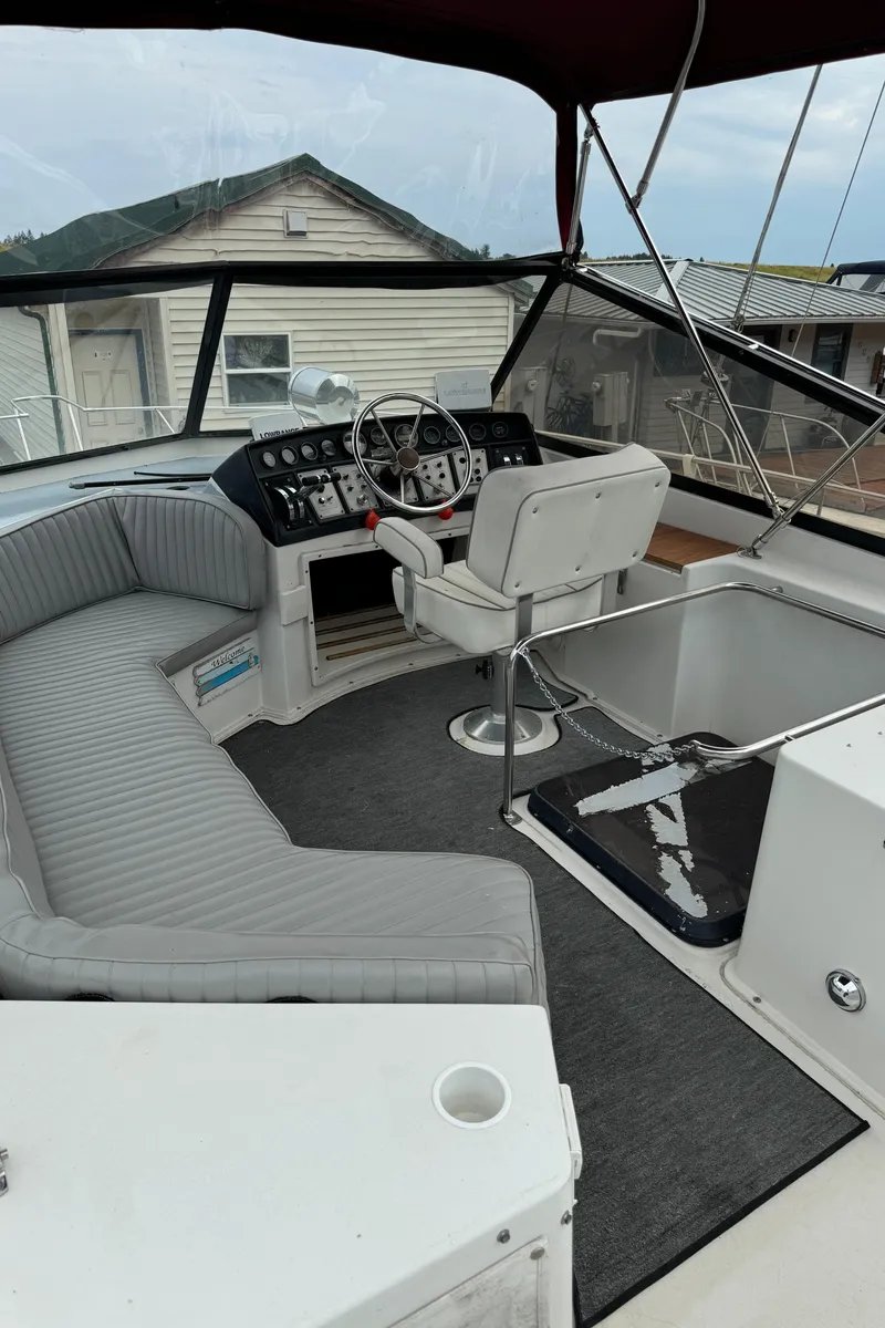 Slide: The Image of 1986 Carver Mariner 3297 boat interior with helm, seating, and controls. - 15