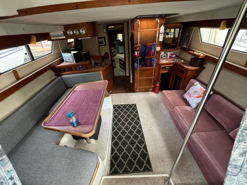 Slide: The Image of Interior of 1986 Carver Mariner 3297 yacht with cozy seating and dining area. - 2
