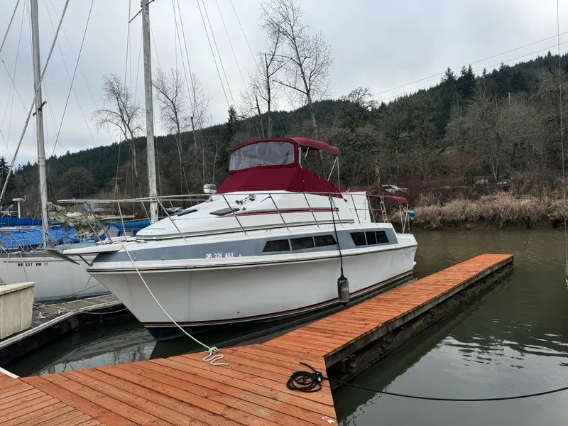 Slide: The Image of 1986 Carver Mariner 3297 docked on a calm lake with wooded background. - 20