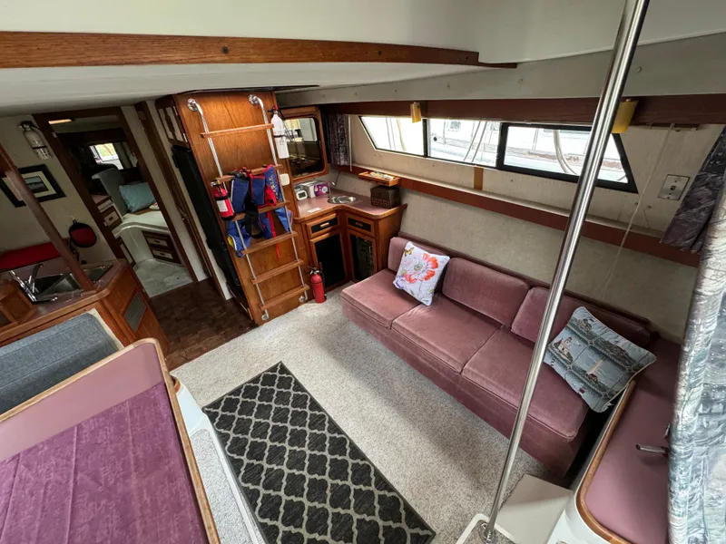 Slide: The Image of Interior of 1986 Carver Mariner 3297 yacht with cozy seating and nautical decor. - 3